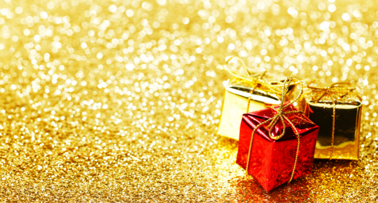 small wrapped gifts against a golden glitter background